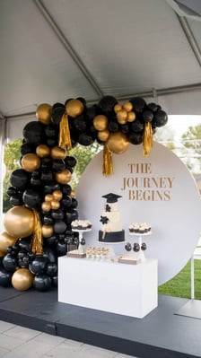 A graduation celebration setup under canvas with cake, balloons and a graduation cap — illustrative of graduation parties and private celebrations at Weir Bank Estate, Bray-on-Thames, Berkshire.