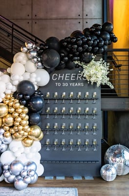 An elegant champagne wall for an anniversary celebration — illustrative of milestone anniversary events and private celebrations at Weir Bank Estate, Bray-on-Thames, Berkshire.