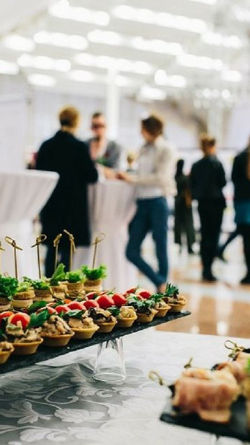 Corporate delegates enjoying a breakout session with buffet catering in view, illustrative of the conference and corporate event facilities available at Weir Bank Estate, Bray-on-Thames, Berkshire.