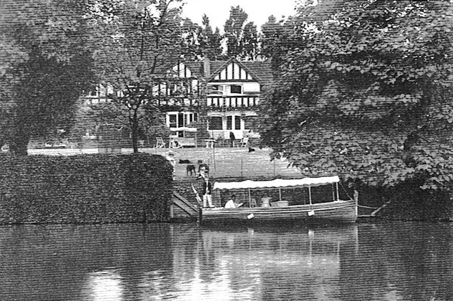 Historic black and white photograph of Weir Bank Estate from the River Thames, showing the original house, private jetty and river boat at Bray-on-Thames, Berkshire.